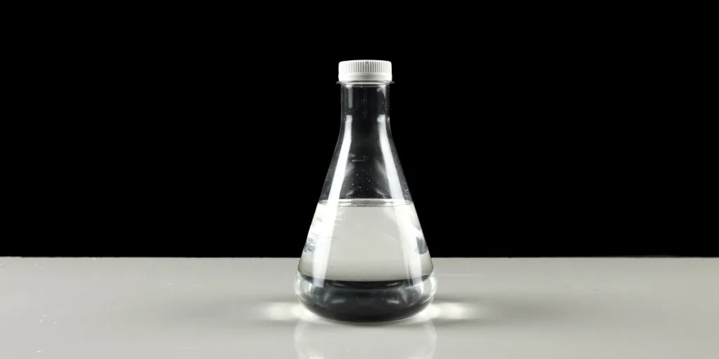 Clear glycerin in a beaker in front of a black background.