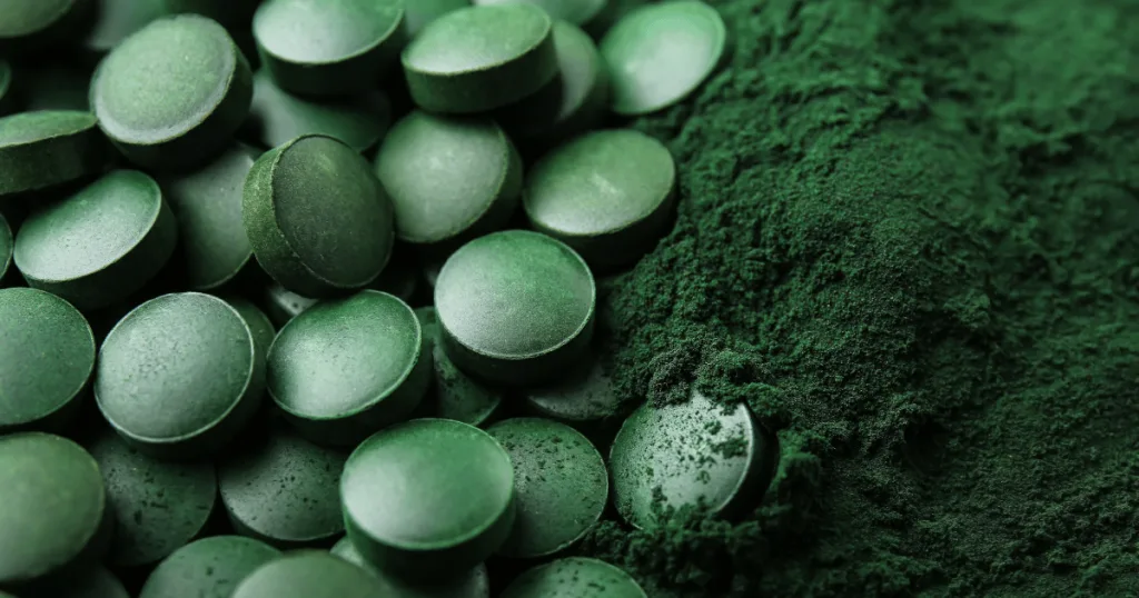 Green tablets nestled on top of green powder.