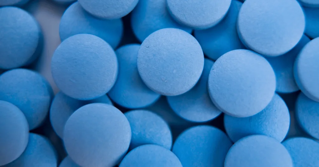 A close up shot of round blue tablets.