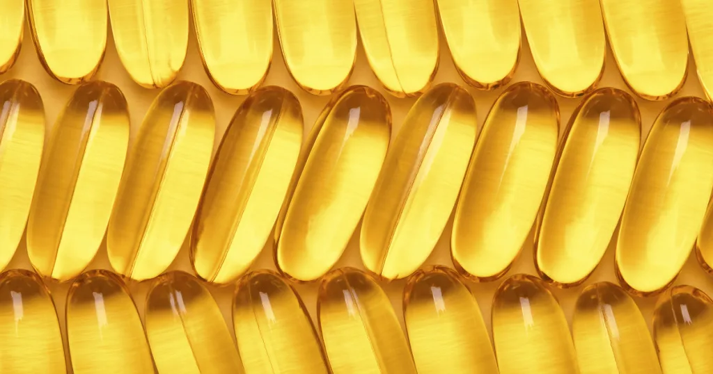 Rows of gel caps filled with yellow liquid.