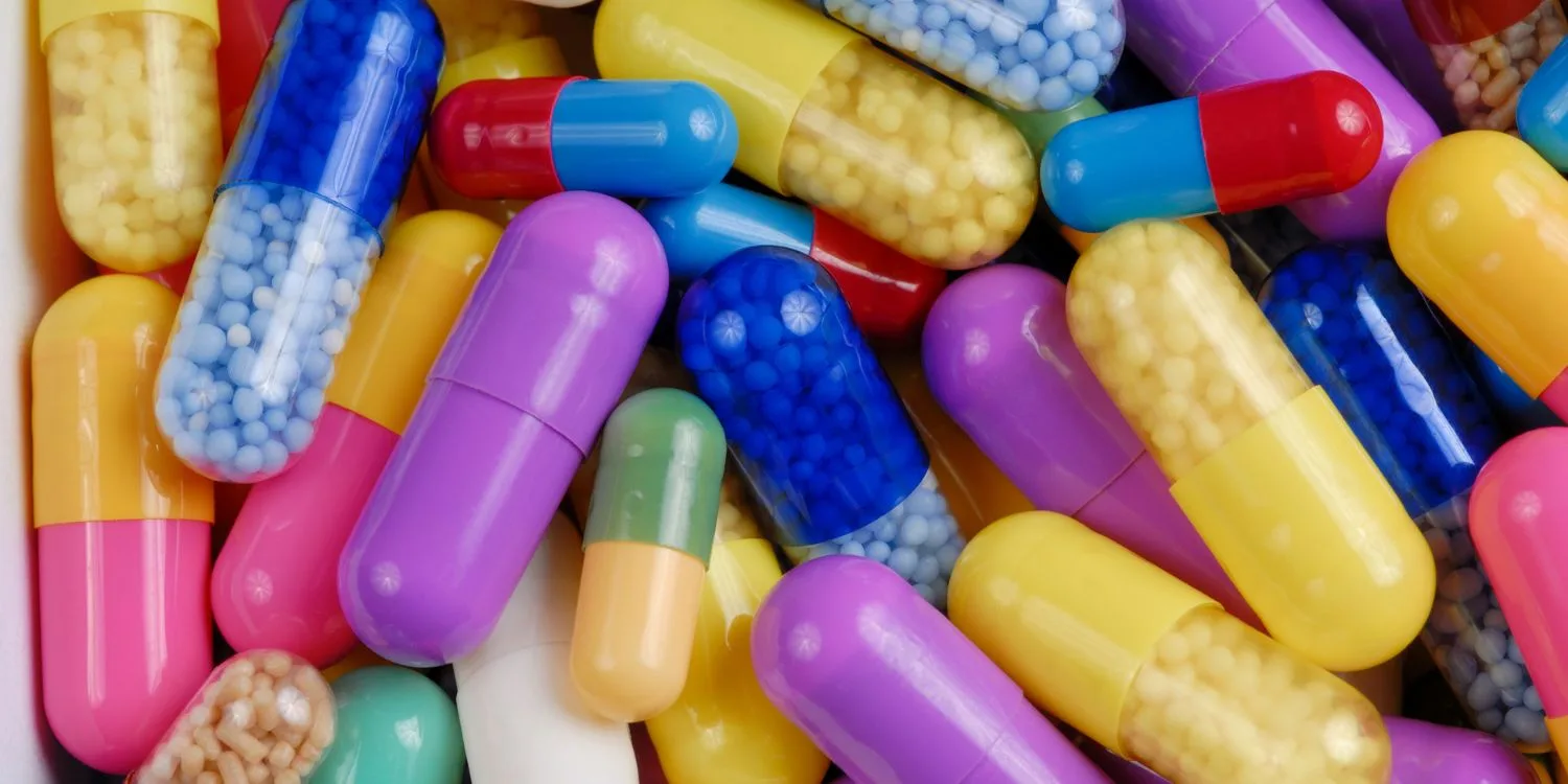 A close-up shot of an assortment of capsules in different colors.