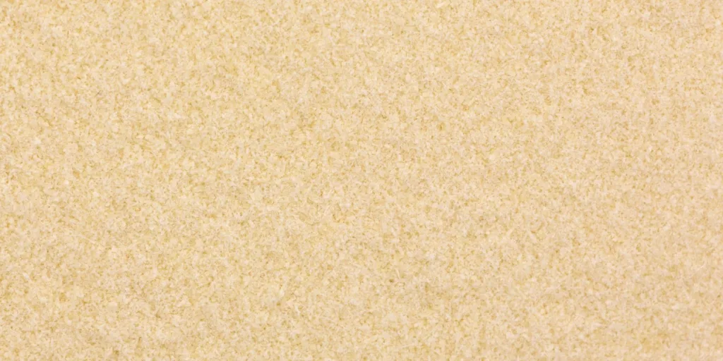 Close-up of tan/yellow xanthan gum powder granules.